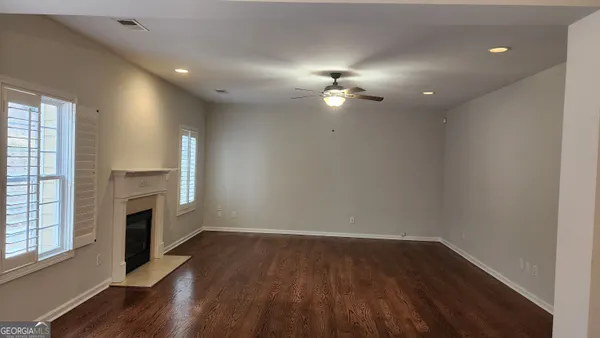 wooden floor in an empty room with a fireplace