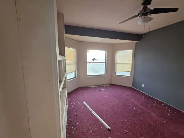 an empty room with windows and closet