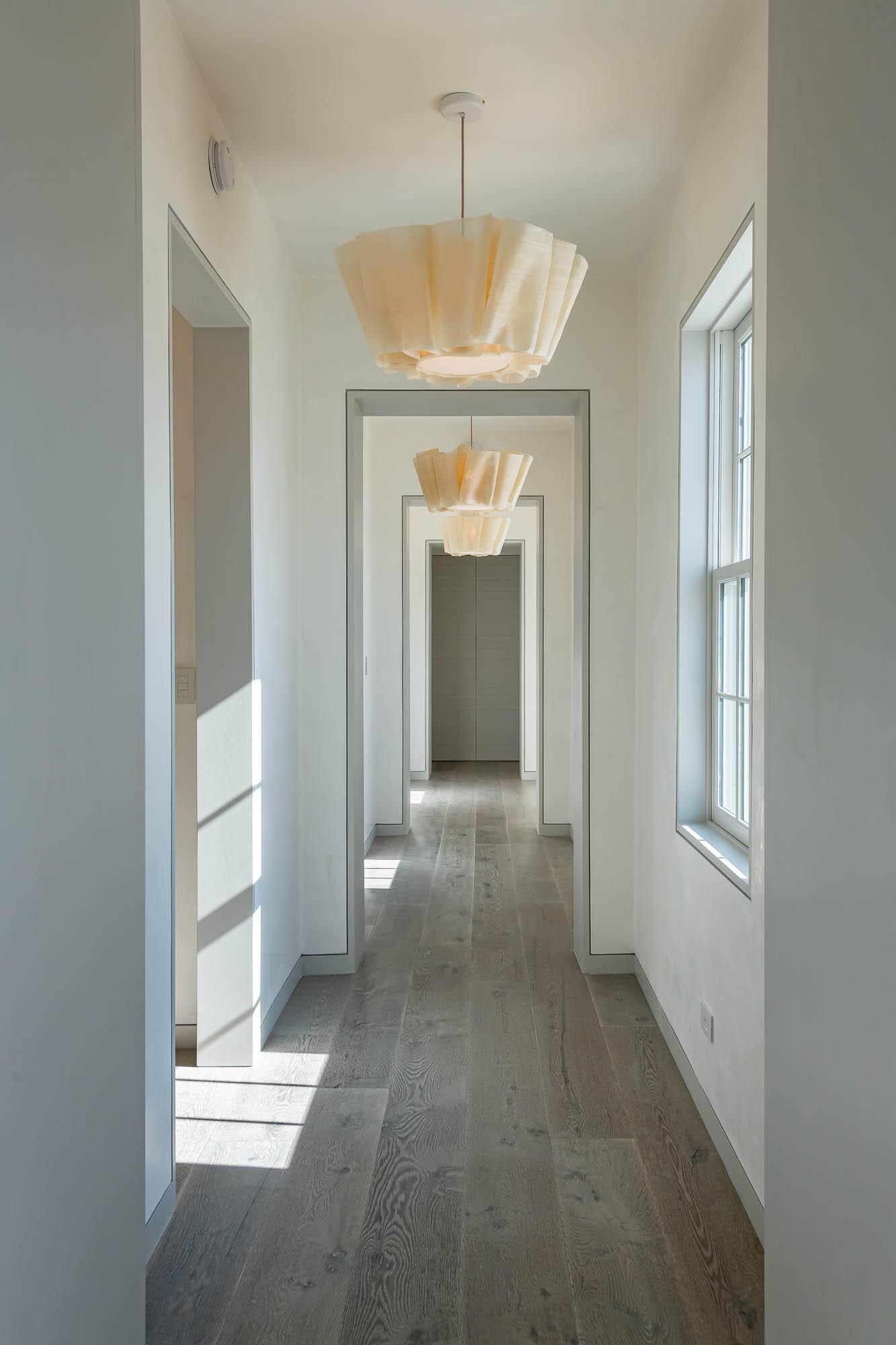 32 Mcgee Dr Inlet Beach Inlet Beach, FL 32461 - Photo 26 of 54 a view of a hallway with windows and chandelier