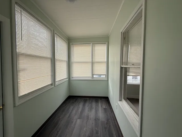 a view of room with window and hardwood floor
