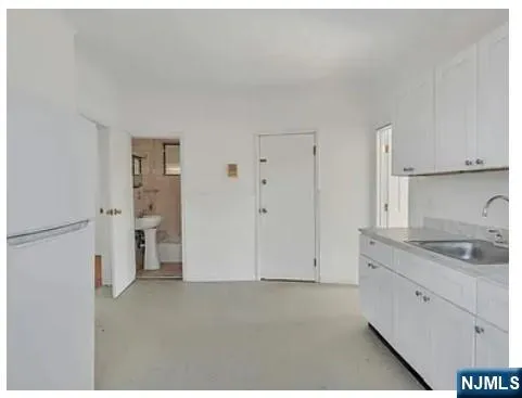 a kitchen with white cabinets