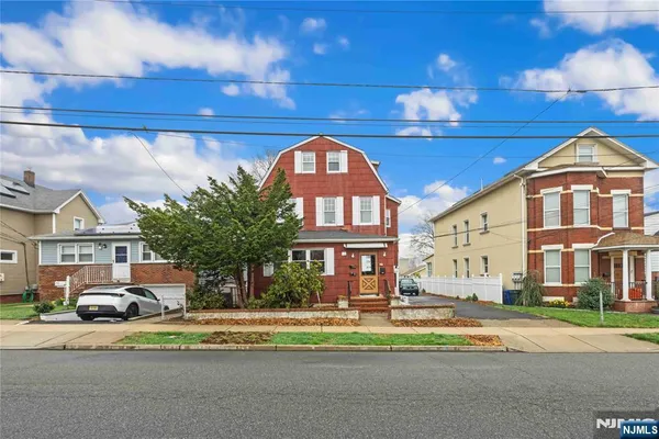 a front view of a multi story residential apartment building with a yard