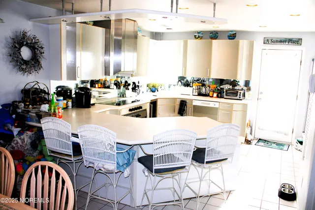 a kitchen with stainless steel appliances kitchen island granite countertop a sink and cabinets