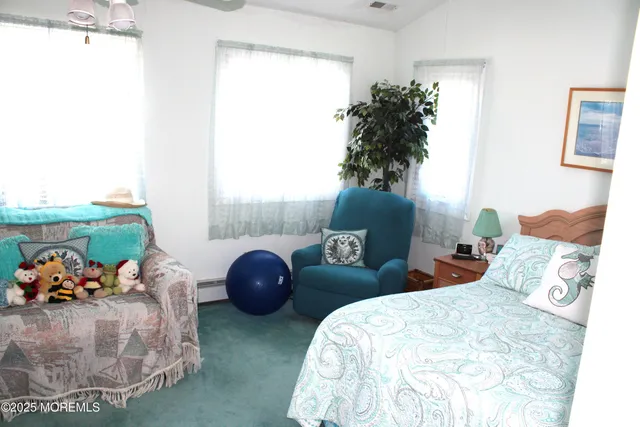 a bedroom with two beds and a potted plant