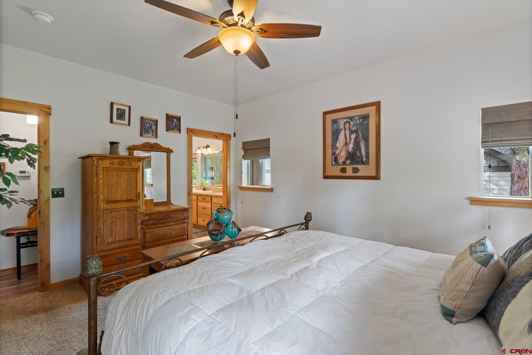 105 Window Lake Trail Durango, CO 81301 - Photo 16 of 36 a bedroom with a bed and a chandelier