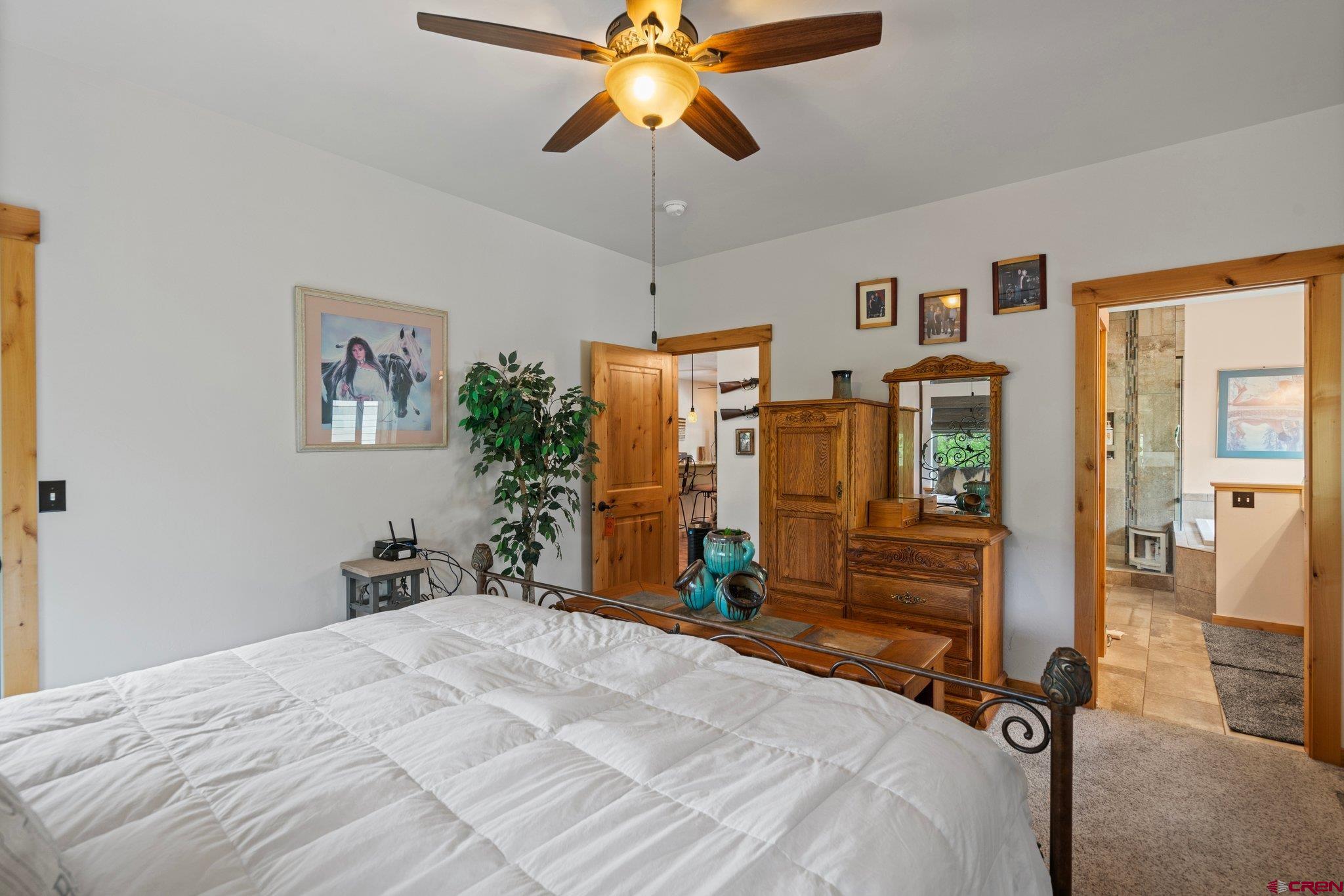 105 Window Lake Trail Durango, CO 81301 - Photo 17 of 36 a bedroom with a bed and a chandelier