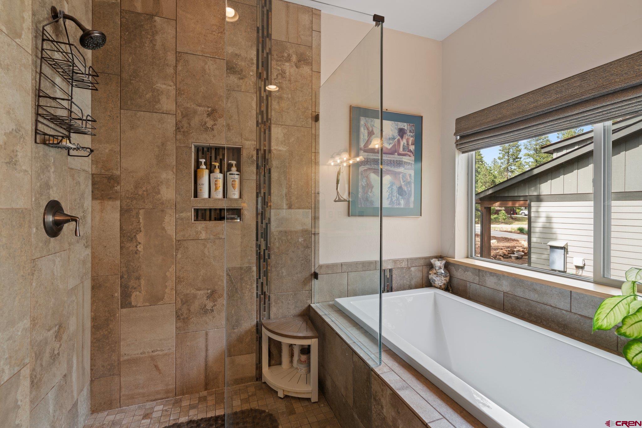 105 Window Lake Trail Durango, CO 81301 - Photo 20 of 36 a bathroom with a bathtub and a shower