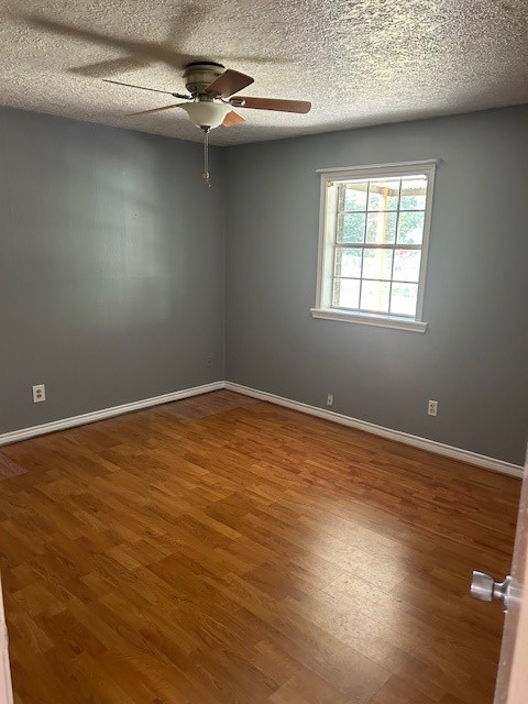 302 Arrowhead Drive Conroe, TX 77316 - Photo 16 of 23 wooden floor in an empty room with a window