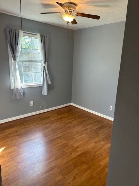 302 Arrowhead Drive Conroe, TX 77316 - Photo 17 of 23 an empty room with wooden floor and windows