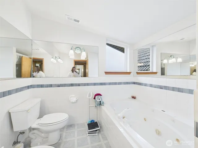 a bathroom with a sink toilet and a mirror