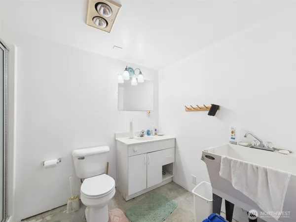 a bathroom with a sink a toilet and a mirror