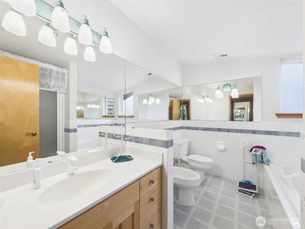 a bathroom with a sink vanity granite and toilet