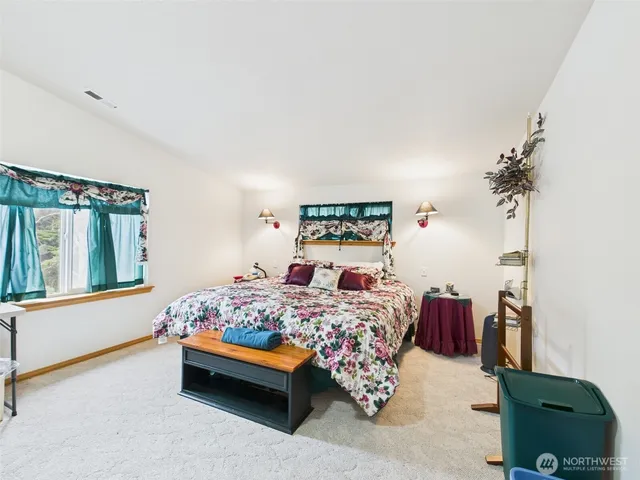 a bedroom with two beds and a large window