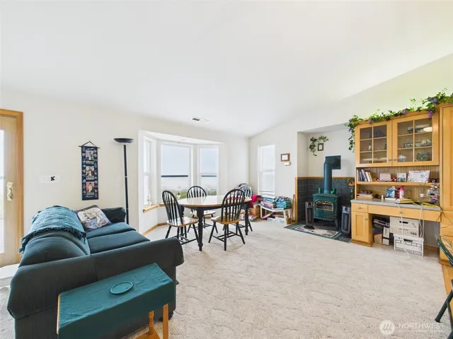 a large white kitchen with stainless steel appliances granite countertop a stove and a sink