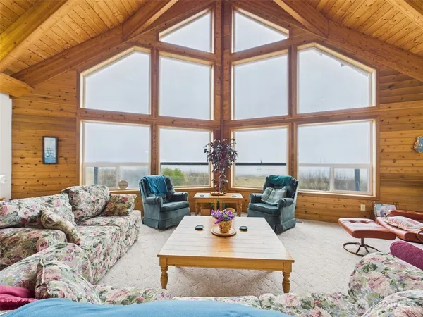 a living room with furniture and large windows