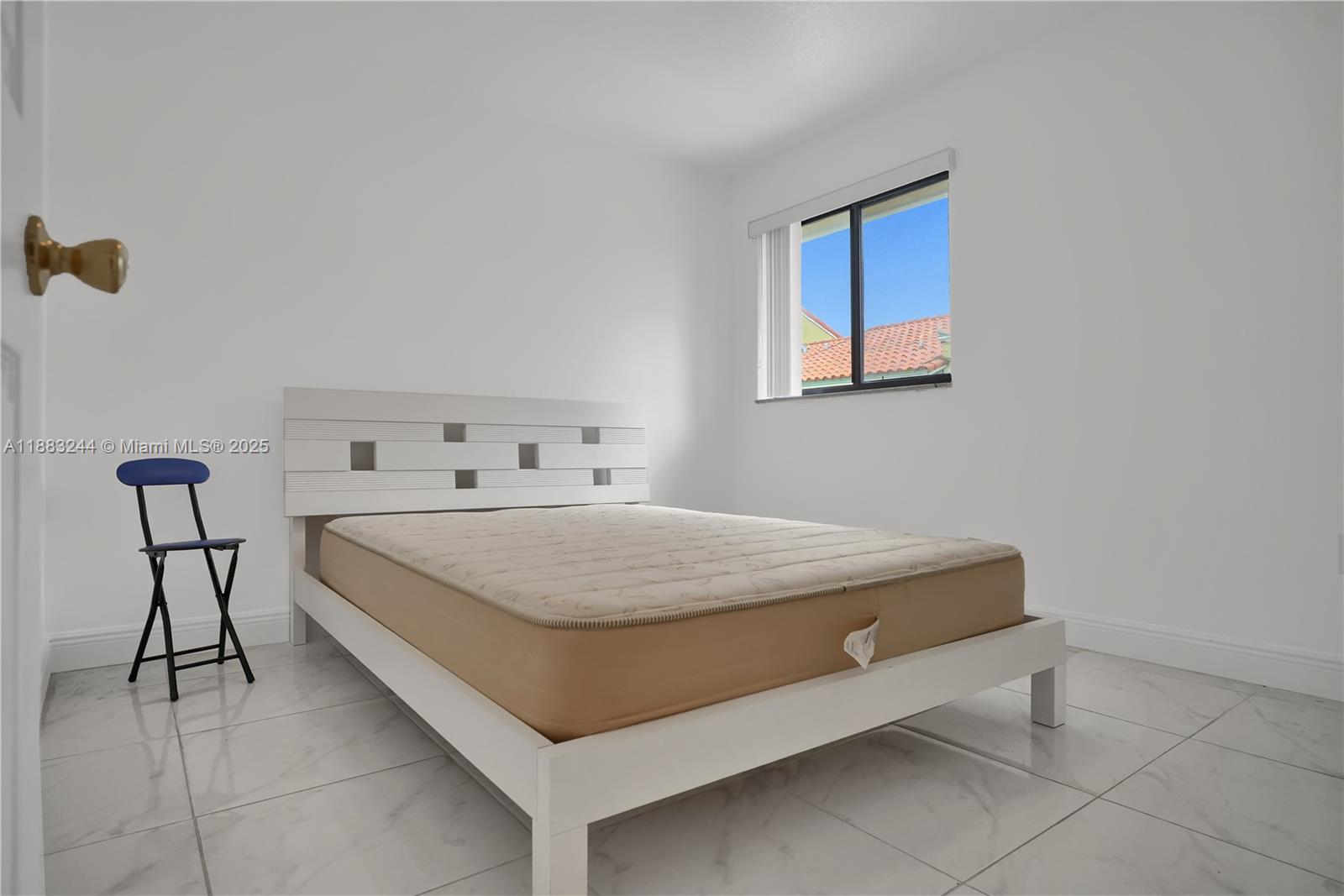 2740 West 61st Street, Unit 204 Hialeah, FL 33016 - Photo 11 of 20 a bedroom with a bed and chair