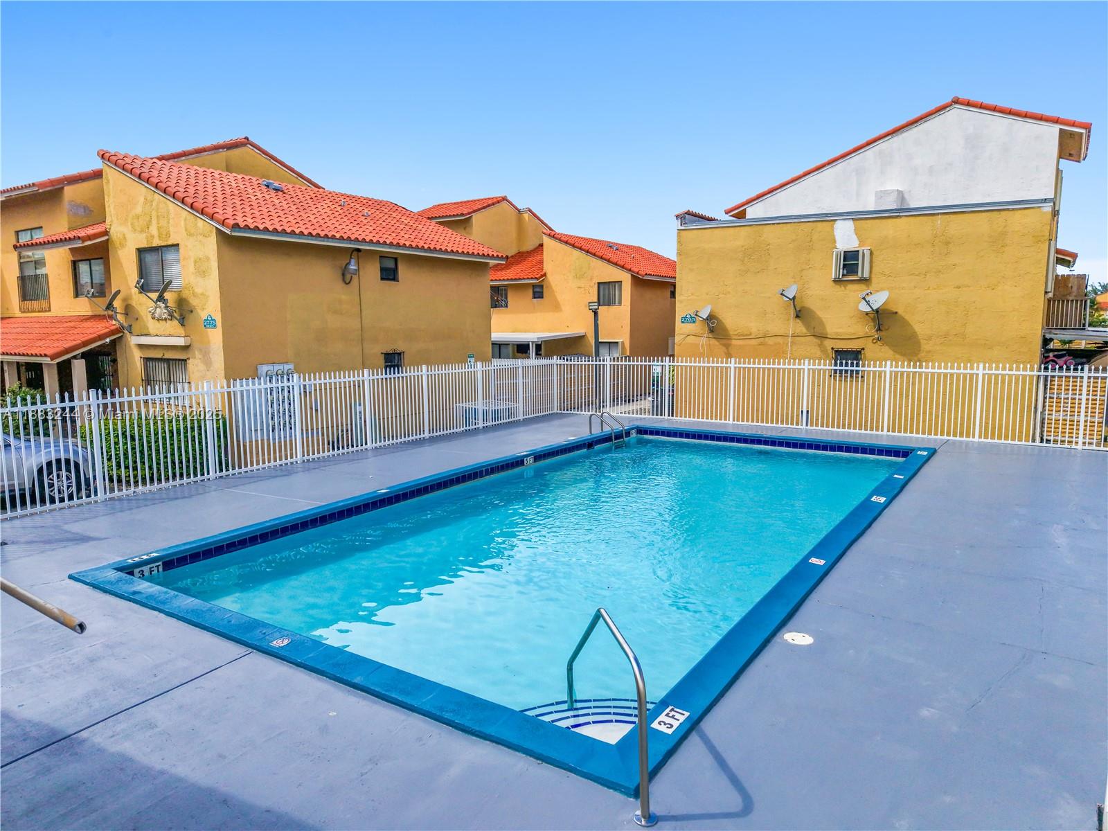 2740 West 61st Street, Unit 204 Hialeah, FL 33016 - Photo 13 of 20 a view of an swimming pool with a yard