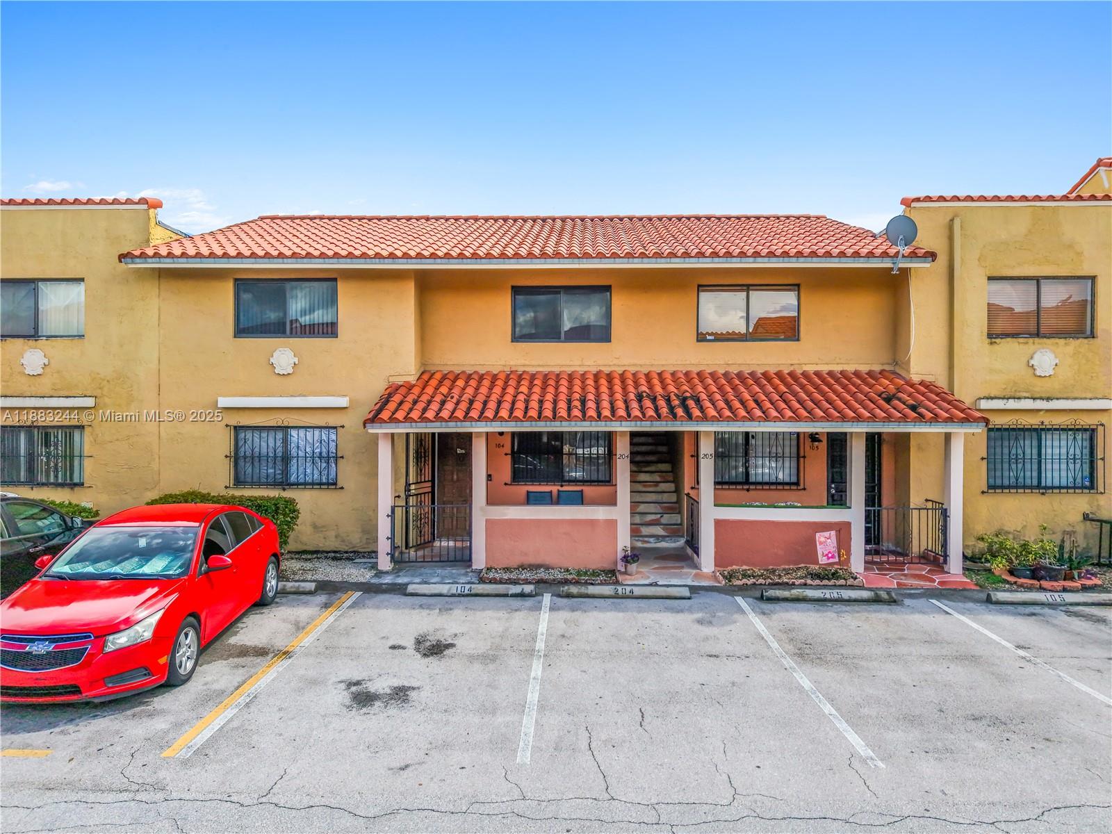 2740 West 61st Street, Unit 204 Hialeah, FL 33016 - Photo 20 of 20 a front view of a house with entryway