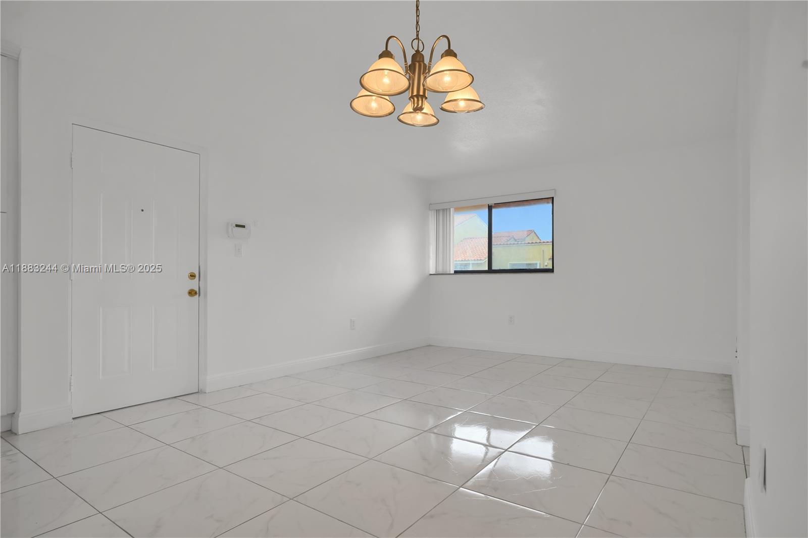 2740 West 61st Street, Unit 204 Hialeah, FL 33016 - Photo 3 of 20 an empty room with windows and chandelier