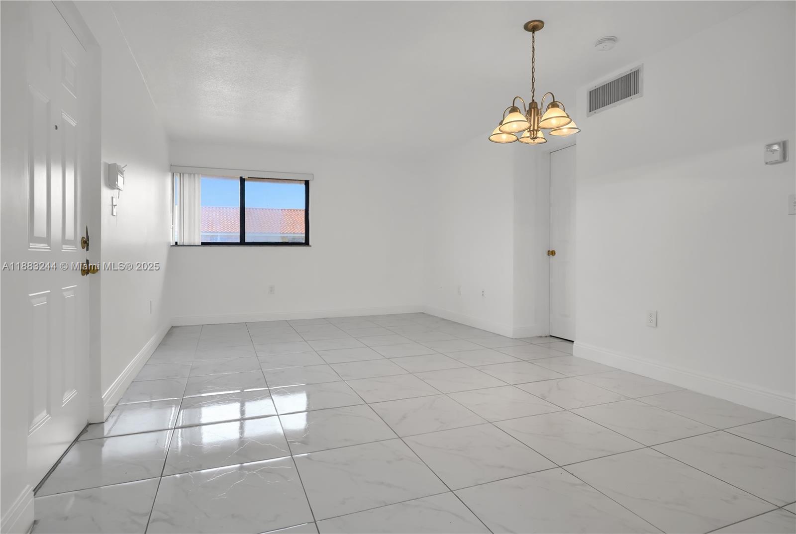 2740 West 61st Street, Unit 204 Hialeah, FL 33016 - Photo 7 of 20 an empty room with windows and chandelier
