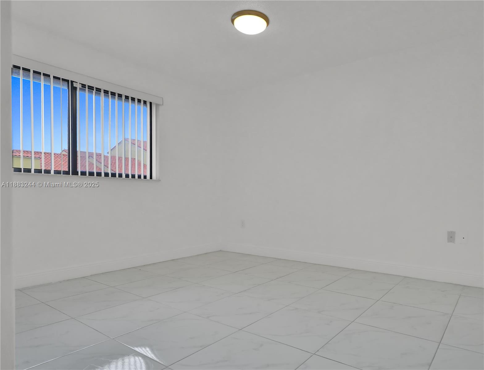 2740 West 61st Street, Unit 204 Hialeah, FL 33016 - Photo 10 of 20 an empty room with a window