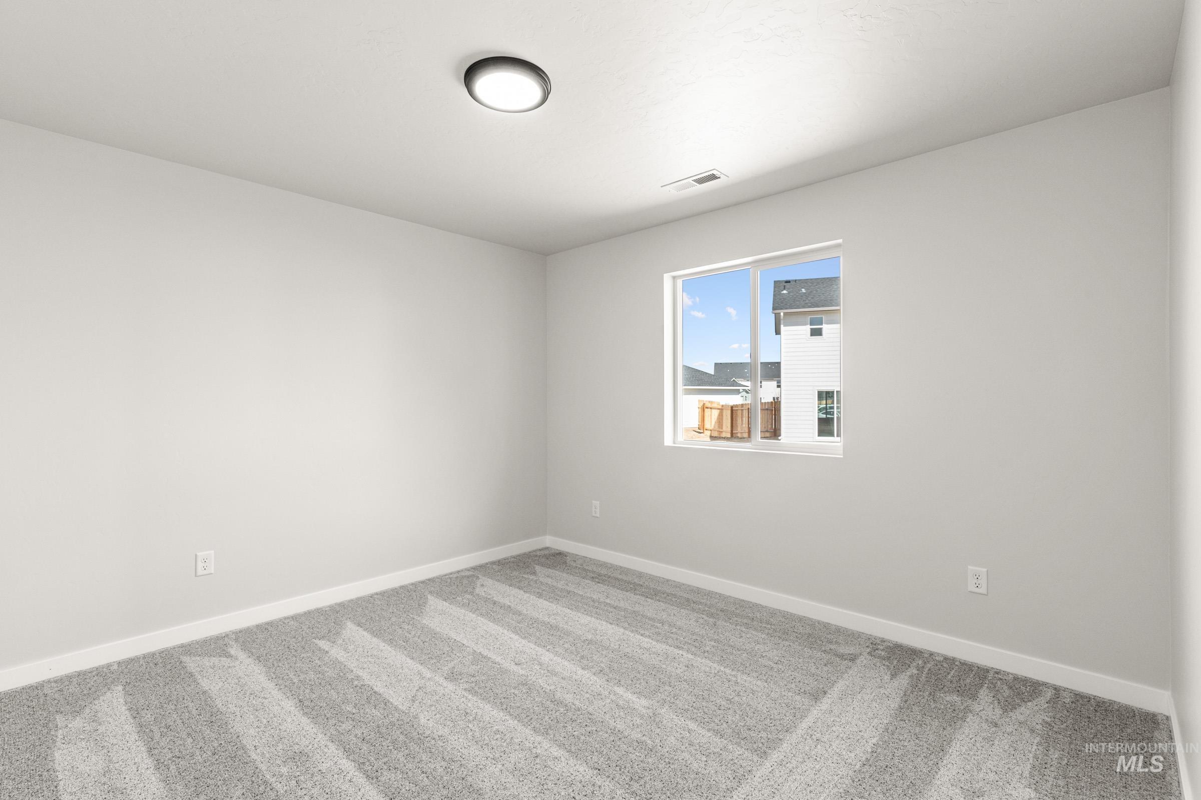 13728 Redway Court Caldwell, ID 83607 - Photo 12 of 19 Spare room with light carpet and baseboards