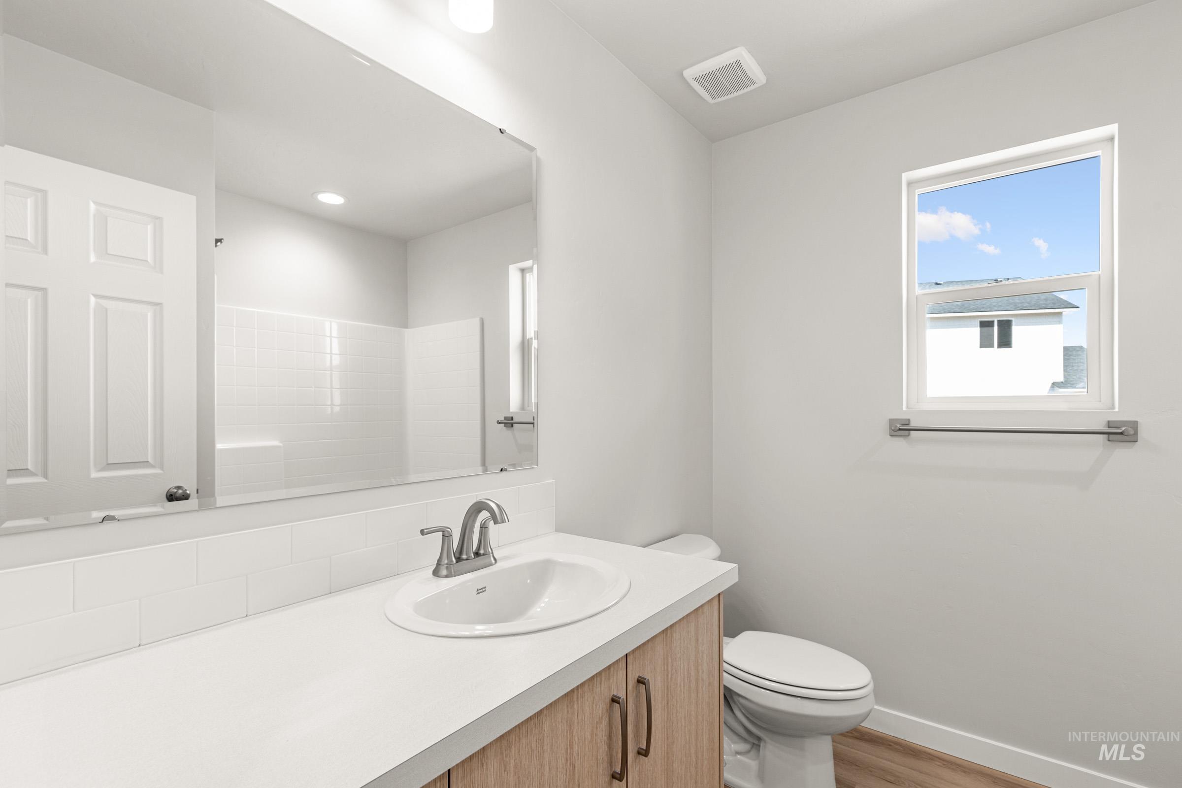 13728 Redway Court Caldwell, ID 83607 - Photo 13 of 19 Full bathroom with vanity, light wood-type flooring, and a shower