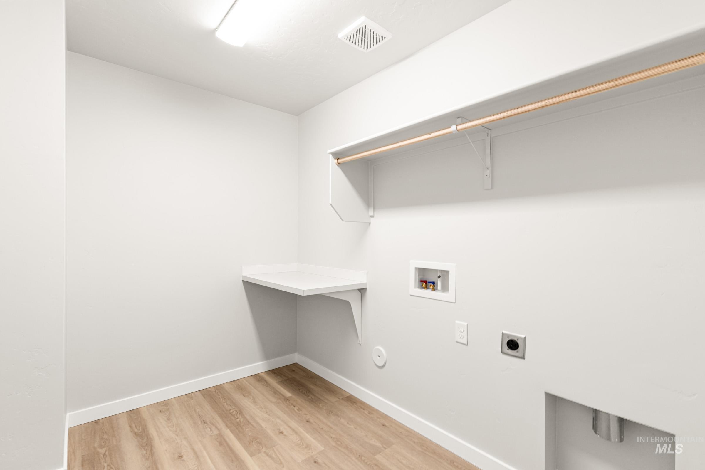 13728 Redway Court Caldwell, ID 83607 - Photo 15 of 19 Laundry room featuring light wood-style flooring, washer hookup, and hookup for an electric dryer