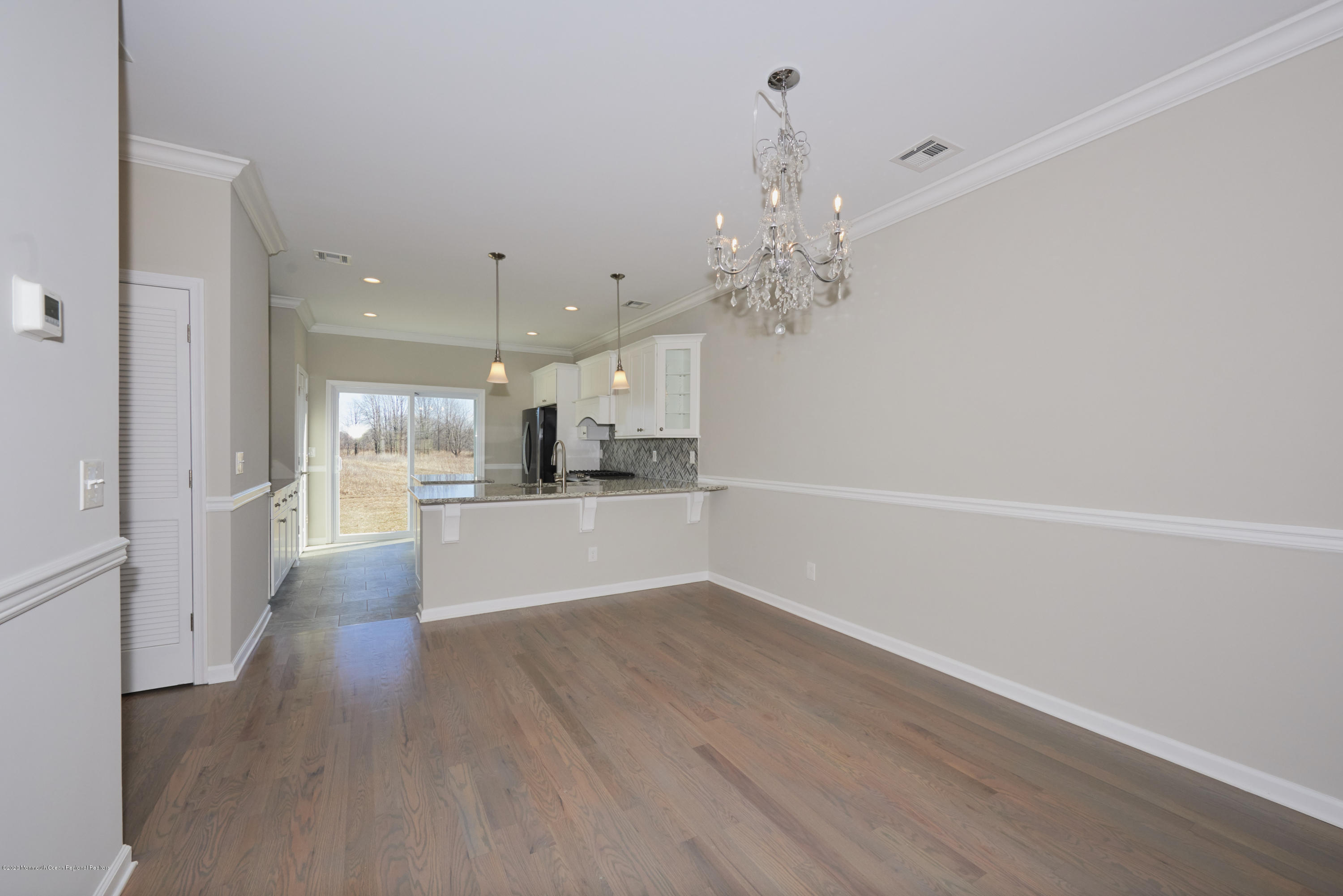 23 Green Tree Circle Hazlet, NJ 07730 - Photo 11 of 38 a view of a hallway with wooden floor and a kitchen