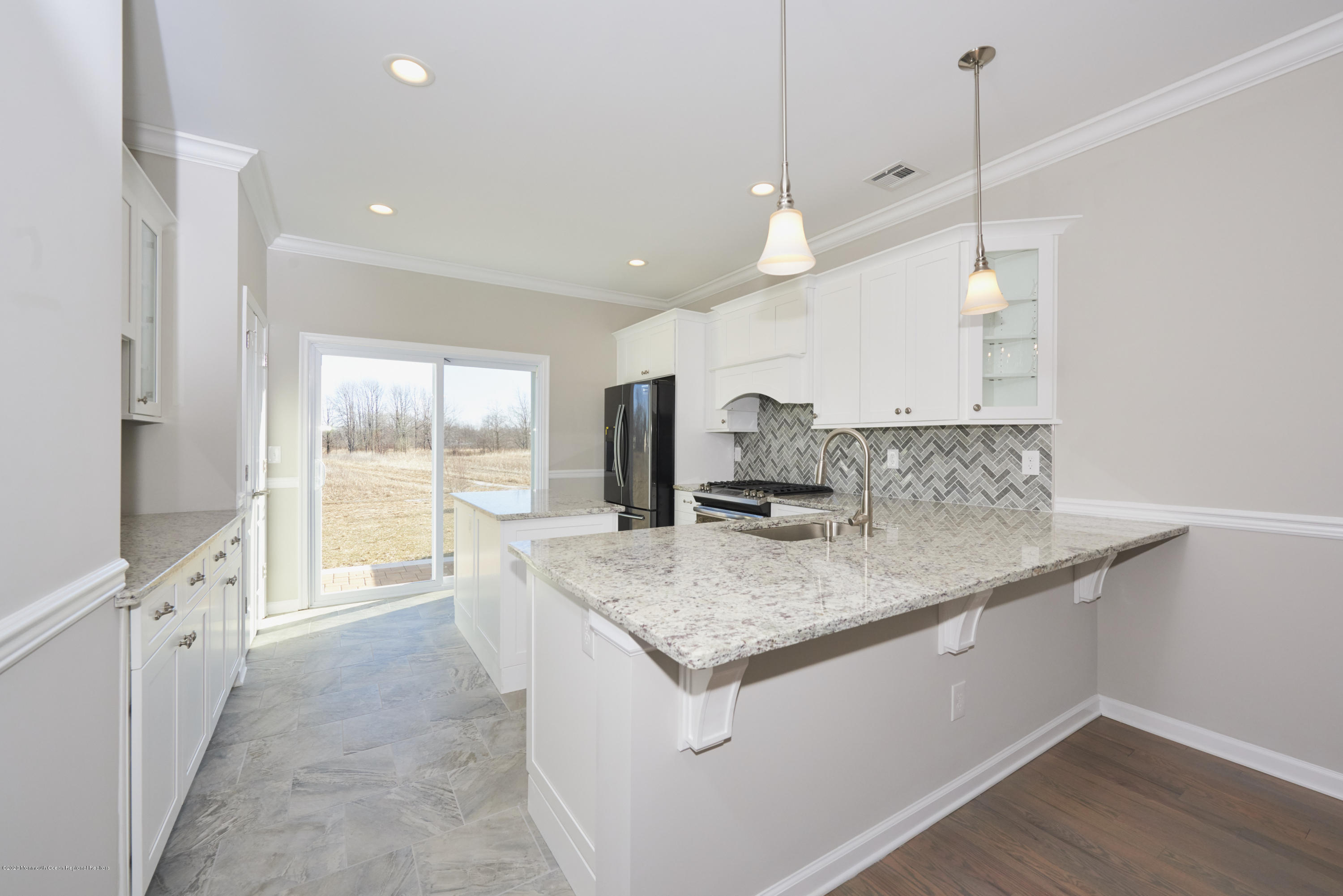 23 Green Tree Circle Hazlet, NJ 07730 - Photo 2 of 38 a kitchen with stainless steel appliances granite countertop a sink a stove and a wooden floor