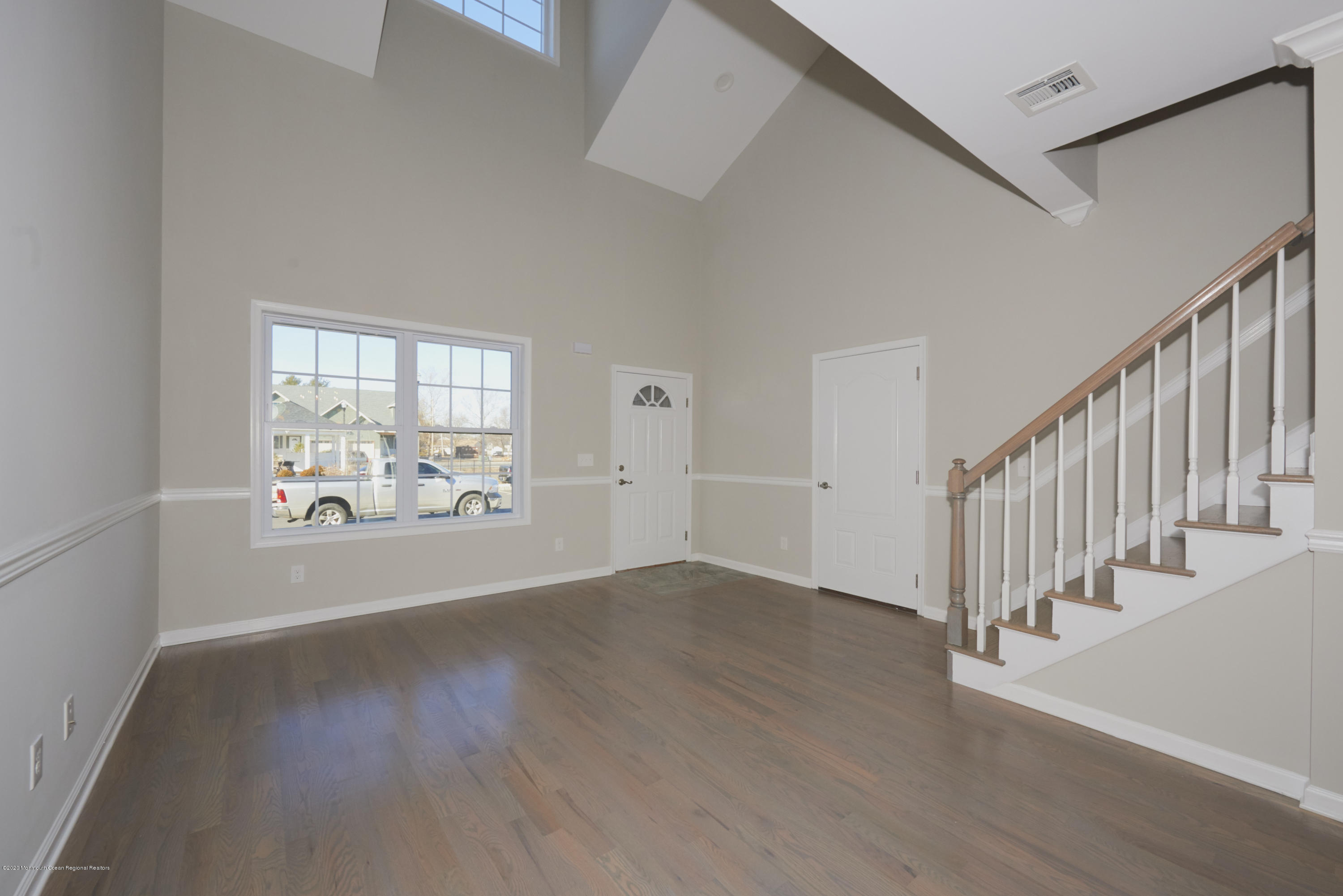 23 Green Tree Circle Hazlet, NJ 07730 - Photo 7 of 38 a view of an empty room with wooden floor and a window