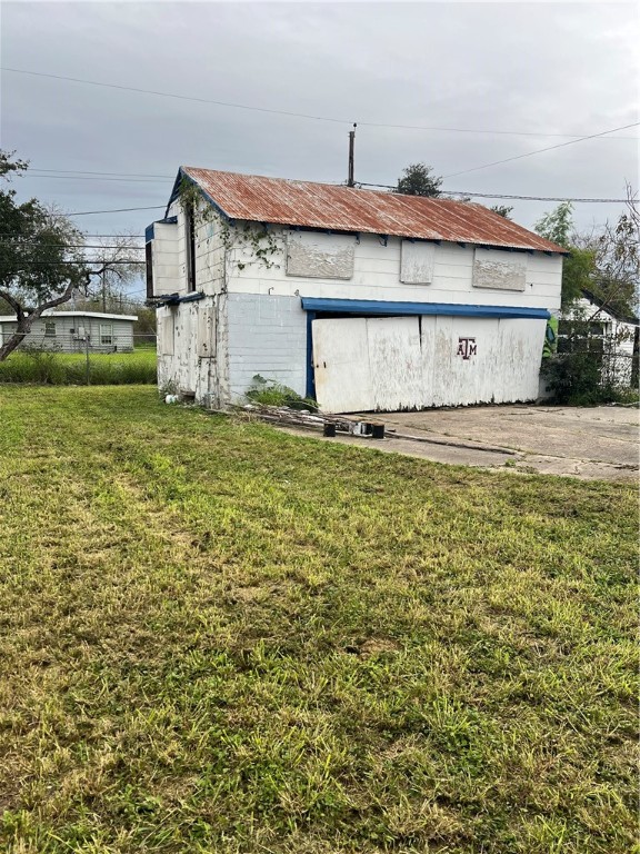 4402 Cottage Street Corpus Christi, TX 78415 - Photo 5 of 10 a big white house with a yard and lawn chairs with wooden fence