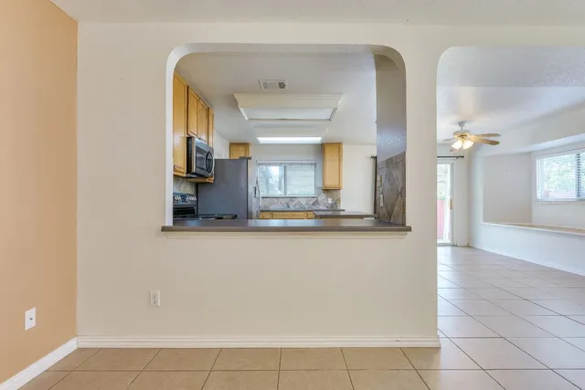 a kitchen with stainless steel appliances granite countertop a refrigerator and a stove top oven