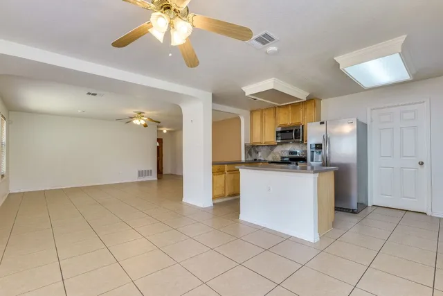 a kitchen with stainless steel appliances granite countertop a stove microwave and refrigerator