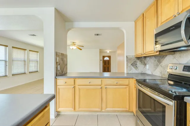 a kitchen with cabinets and window