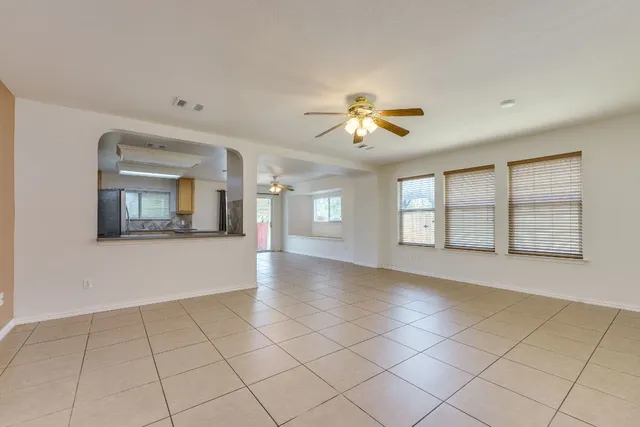 a view of an empty room with a window and fireplace