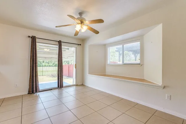 a spacious bathroom with a granite countertop sink a mirror and a bathtub with shower