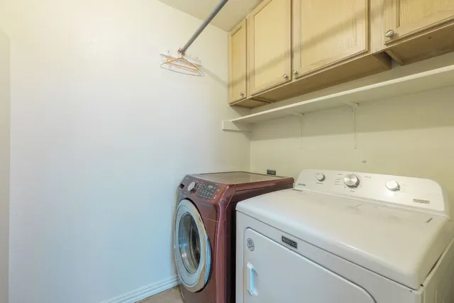a view of a room with wooden walls and a window