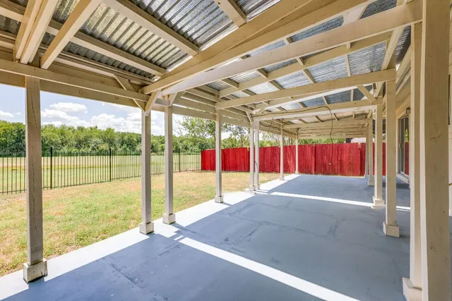 a view of backyard of house with green space