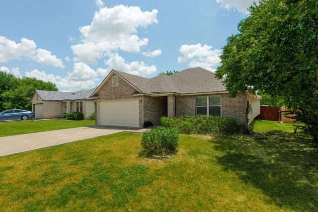 a view of empty room with window and chandelier fan