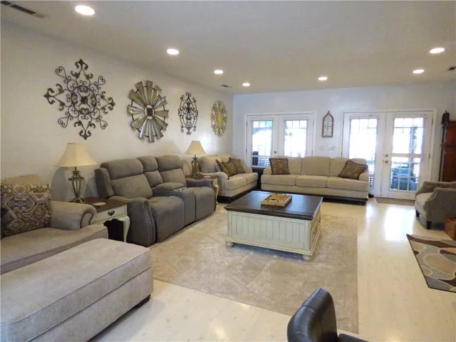a living room with furniture a large window and a table