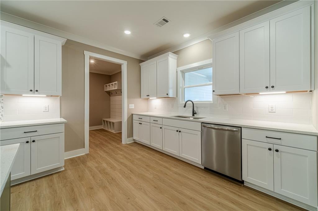 327 Pine Circle Monroe, GA 30655 - Photo 16 of 69 a kitchen with granite countertop white cabinets and white appliances