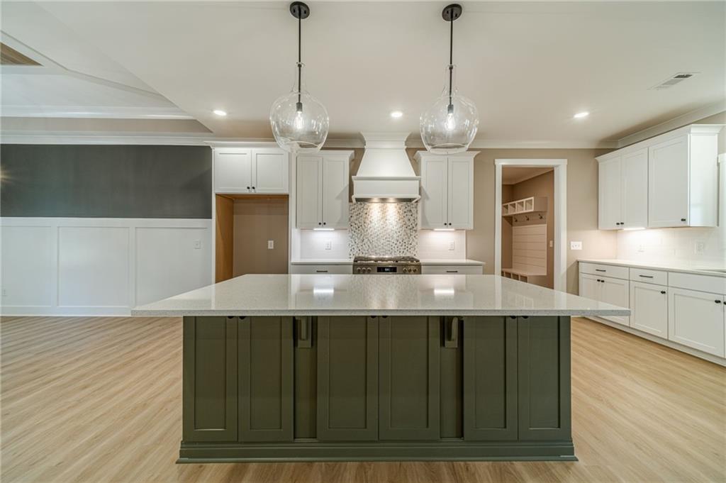 327 Pine Circle Monroe, GA 30655 - Photo 17 of 69 a large kitchen with kitchen island a large island in it