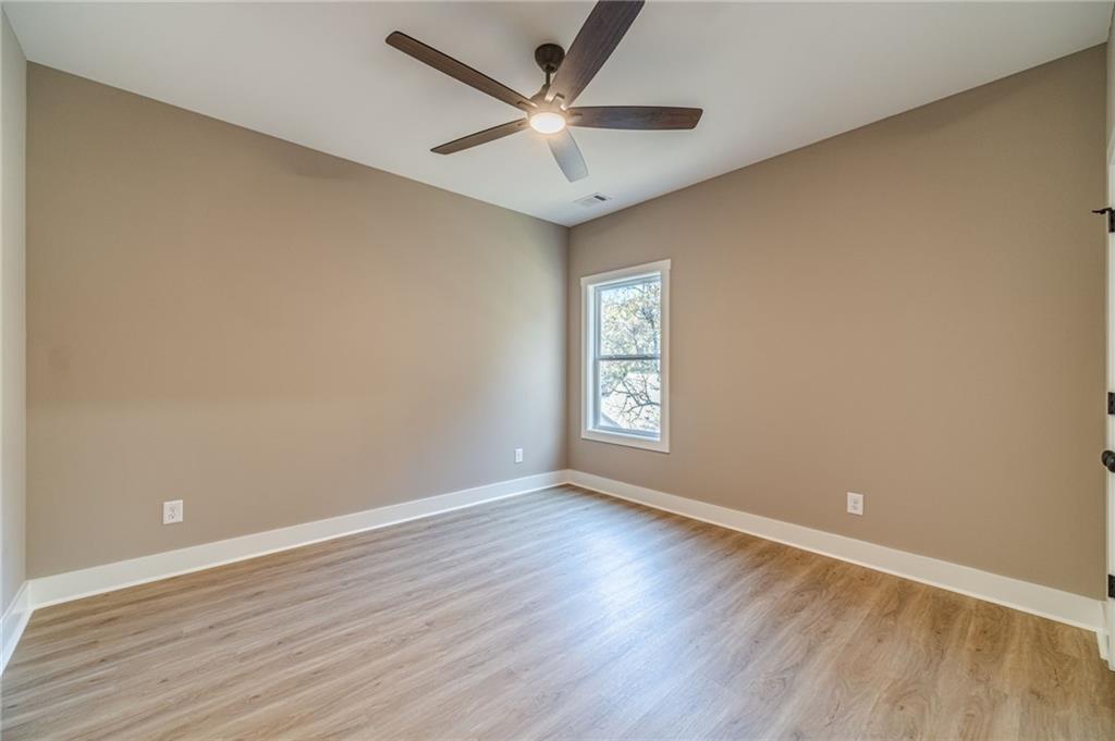 327 Pine Circle Monroe, GA 30655 - Photo 22 of 69 an empty room with a window and a ceiling fan