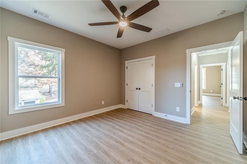 327 Pine Circle Monroe, GA 30655 - Photo 23 of 69 a view of an empty room with window and wooden floor