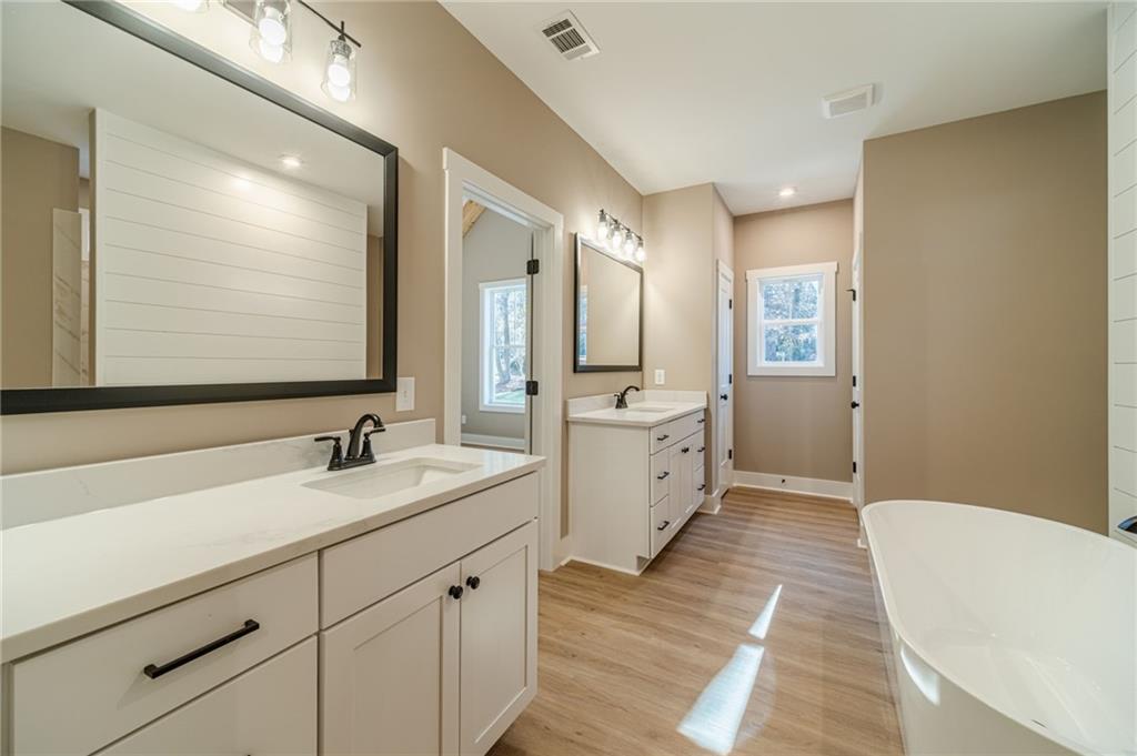327 Pine Circle Monroe, GA 30655 - Photo 36 of 69 a bathroom with a double vanity sink and mirror
