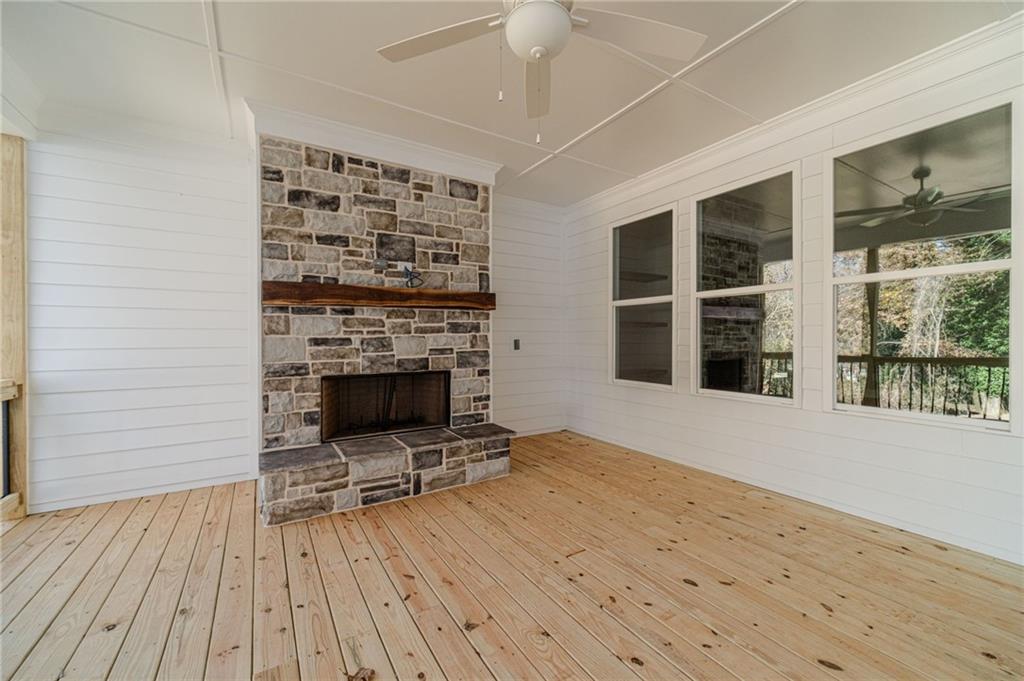 327 Pine Circle Monroe, GA 30655 - Photo 52 of 69 wooden floor fireplace and windows in an empty room