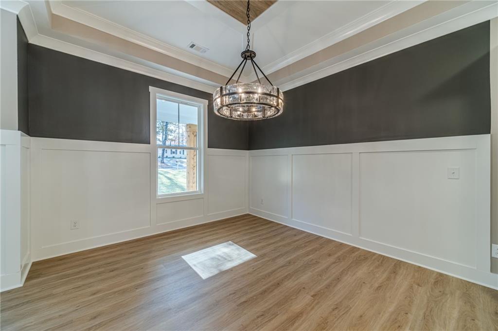 327 Pine Circle Monroe, GA 30655 - Photo 10 of 69 a view of empty room with wooden floor and fan