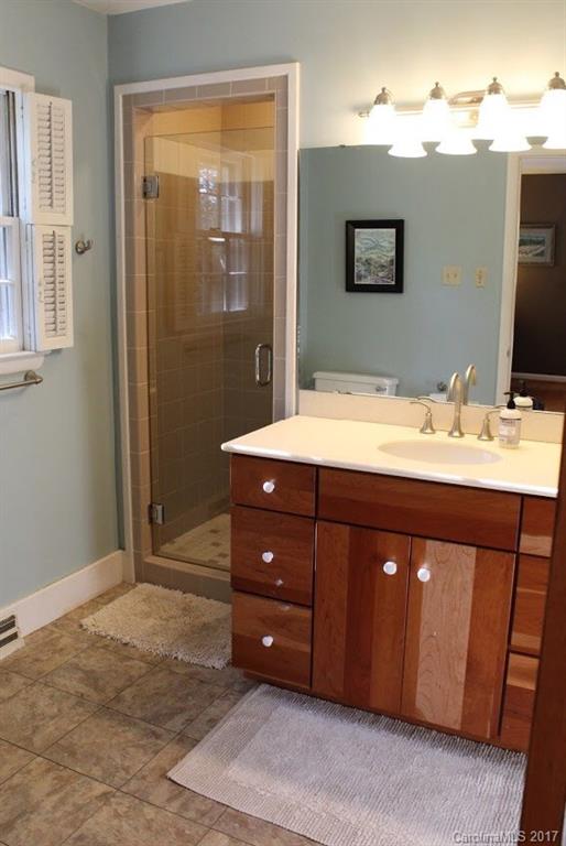 55 Faircrest Road Asheville, NC 28804 - Photo 12 of 20 a bathroom with a sink vanity and a mirror