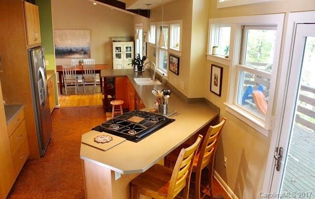 55 Faircrest Road Asheville, NC 28804 - Photo 9 of 20 a view of a dining room with furniture a chandelier and wooden floor